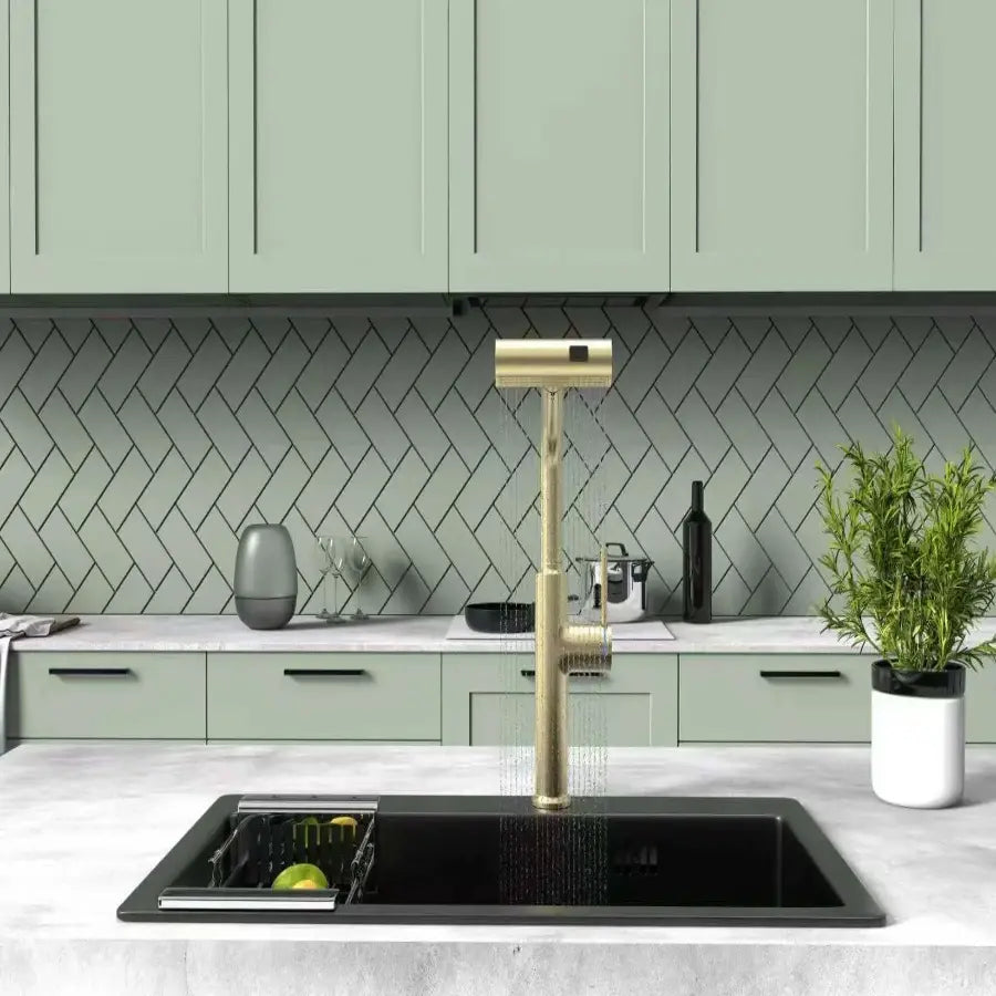 Modern kitchen with a gold faucet and green cabinets